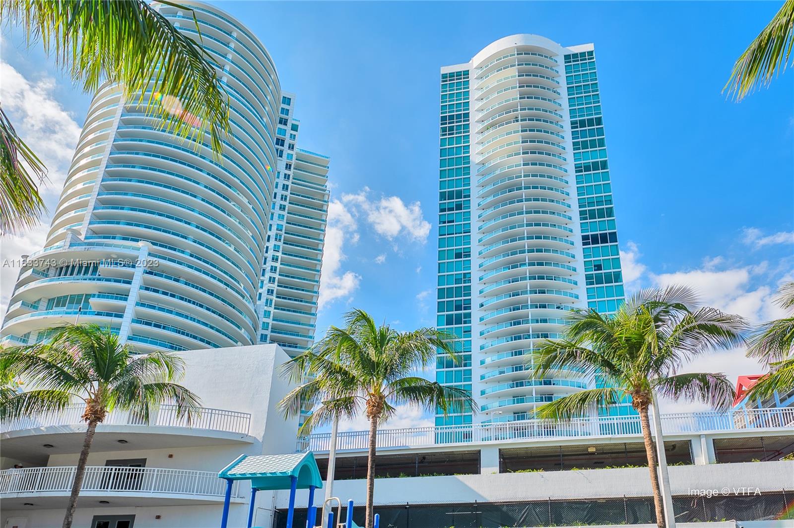 Brickell Miami, FL 33129 - Photo 42 of 44 a front view of multi story residential apartment building with a palm tree