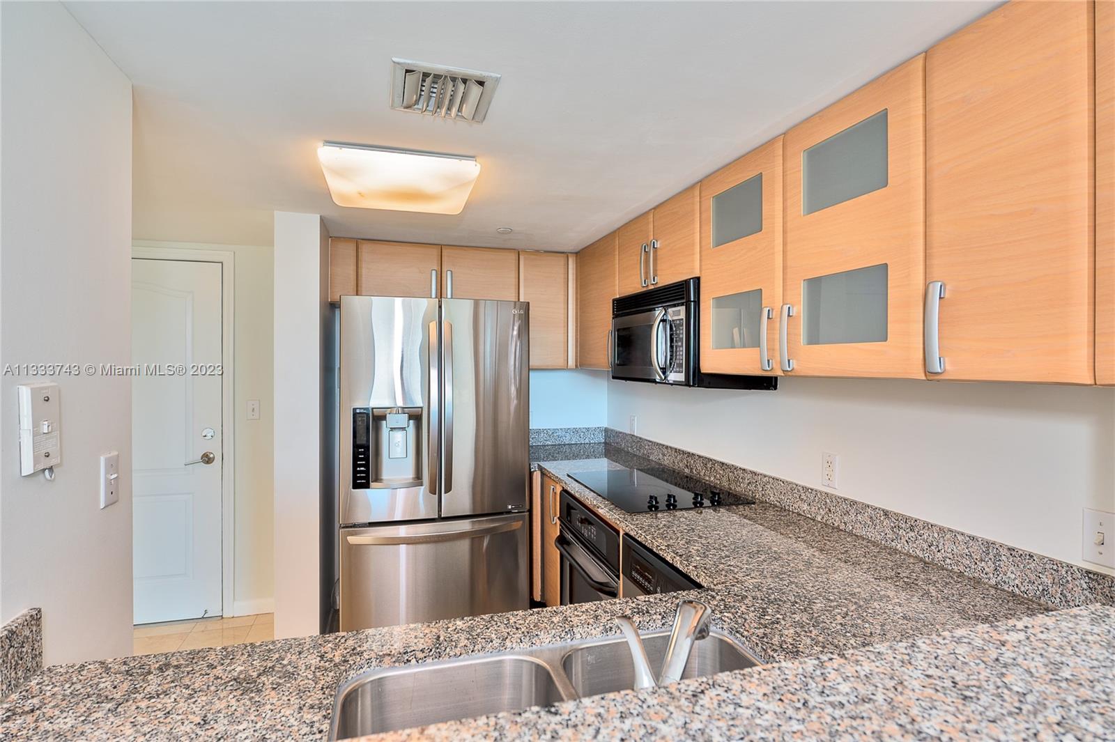 Brickell Miami, FL 33129 - Photo 5 of 44 a kitchen with stainless steel appliances granite countertop a refrigerator and a sink