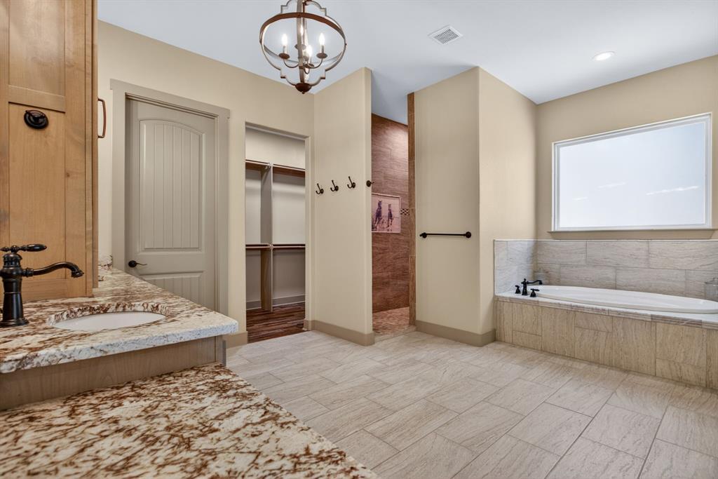 990 Doss Road Millsap, TX 76066 - Photo 22 of 39 a spacious bathroom with a tub and a shower