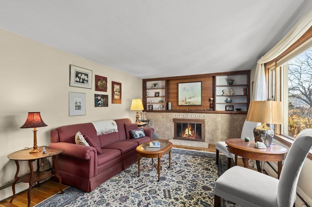9 Lawrence Street Beverly, MA 01915 - Photo 14 of 42 a living room with furniture a flat screen tv and a fireplace
