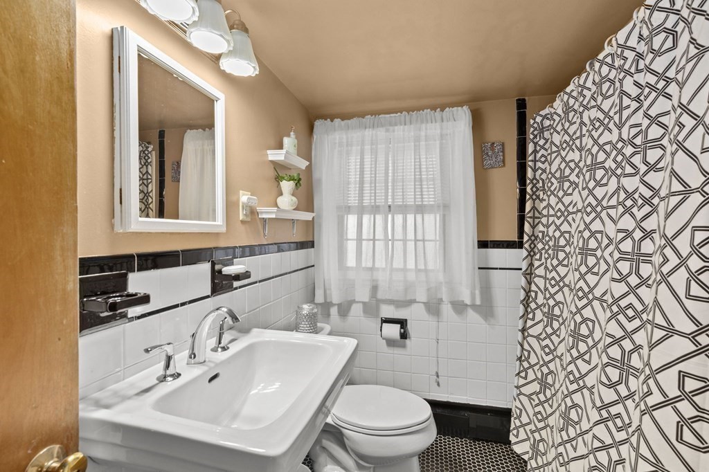 9 Lawrence Street Beverly, MA 01915 - Photo 24 of 42 a bathroom with a sink toilet and mirror