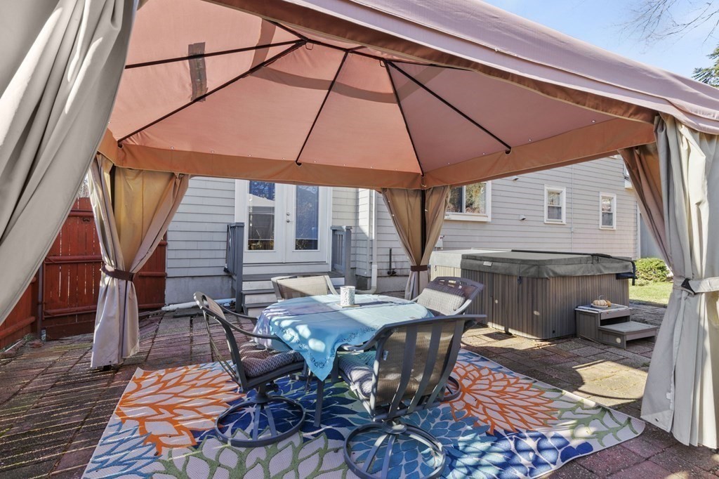 9 Lawrence Street Beverly, MA 01915 - Photo 31 of 42 a view of a patio with table and chairs under an umbrella
