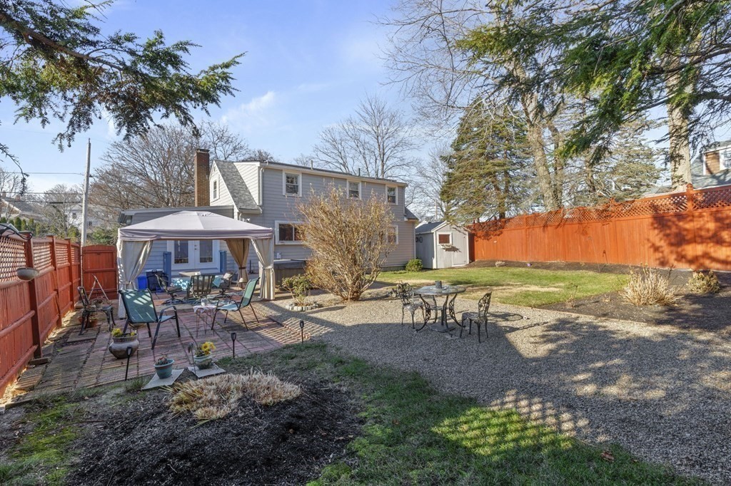 9 Lawrence Street Beverly, MA 01915 - Photo 32 of 42 a view of a patio with table and chairs under an umbrella