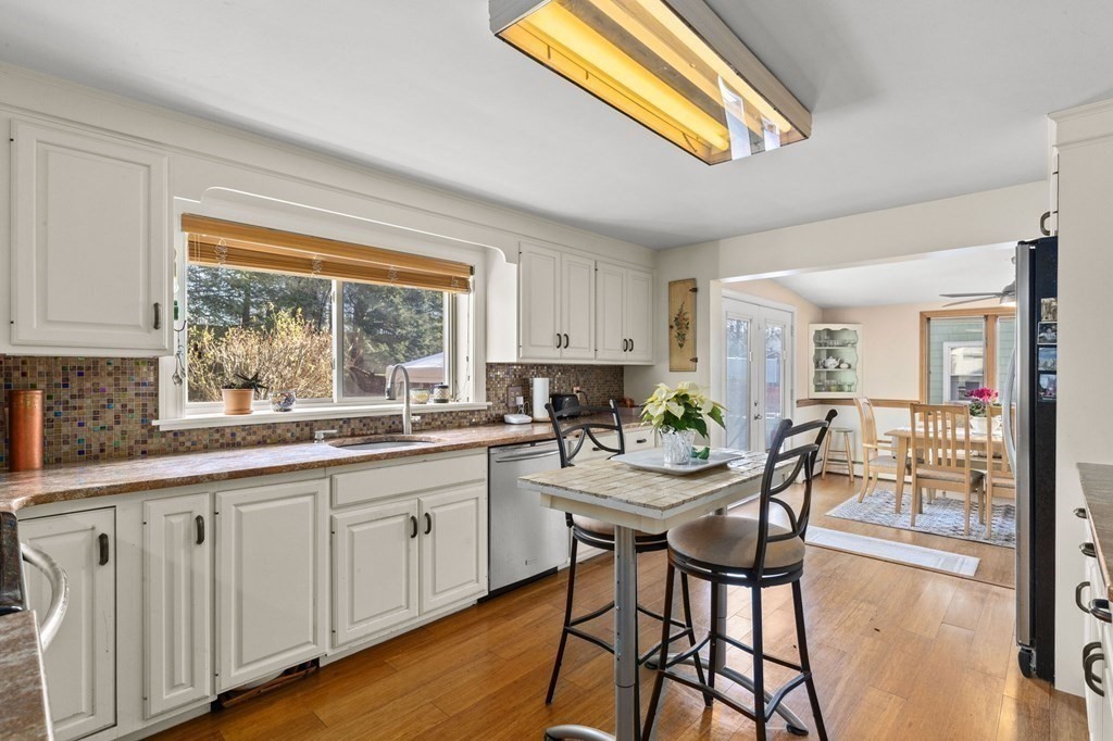 9 Lawrence Street Beverly, MA 01915 - Photo 4 of 42 a kitchen with stainless steel appliances a table and chairs in it