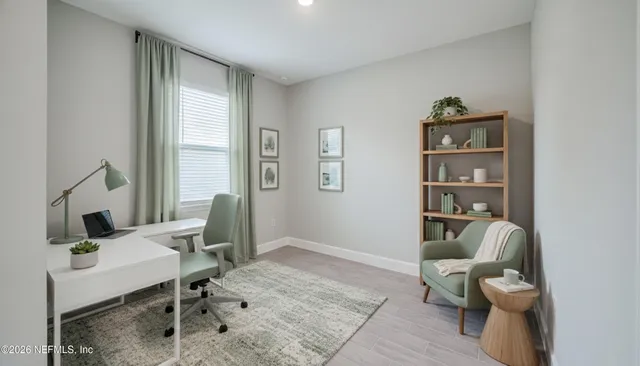 a living room with furniture a rug and a window