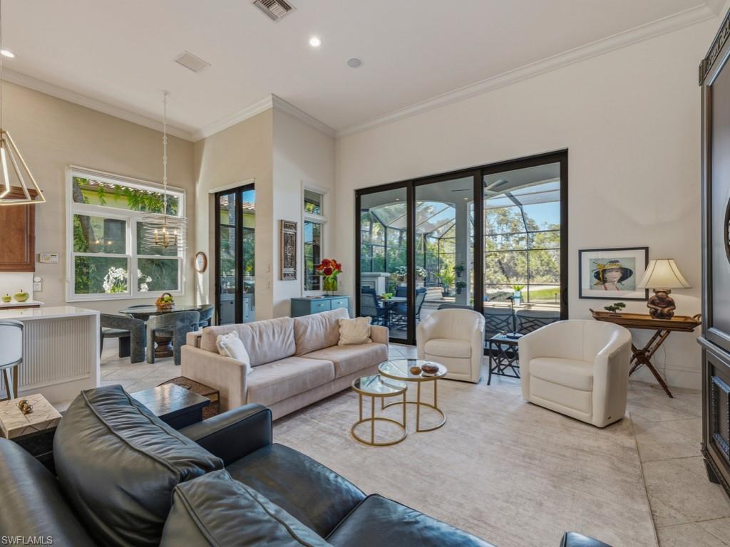 18112 Lagos Way Naples, FL 34110 - Photo 11 of 50 a living room with furniture and floor to ceiling windows