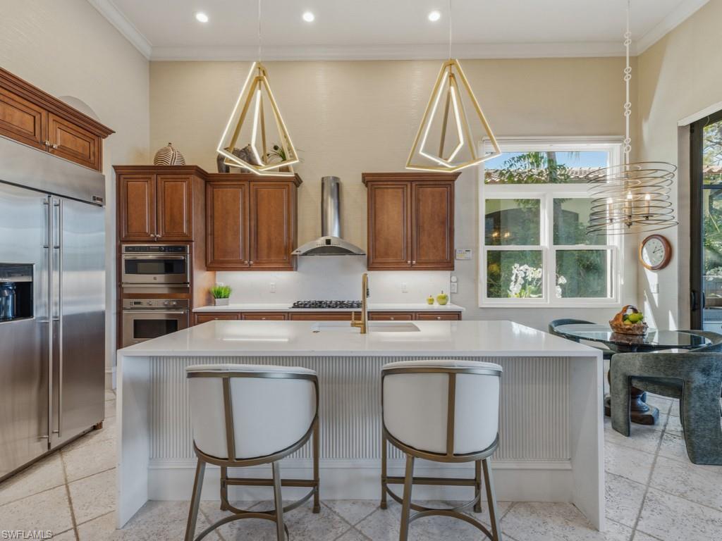 18112 Lagos Way Naples, FL 34110 - Photo 14 of 50 a kitchen with stainless steel appliances a sink and a refrigerator