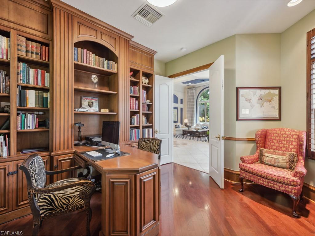 18112 Lagos Way Naples, FL 34110 - Photo 17 of 50 a workspace with furniture and bookshelf