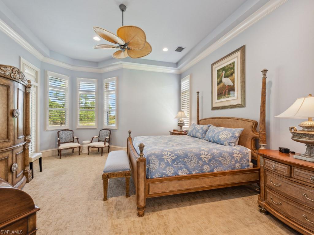 18112 Lagos Way Naples, FL 34110 - Photo 18 of 50 a bedroom with a bed and a chandelier