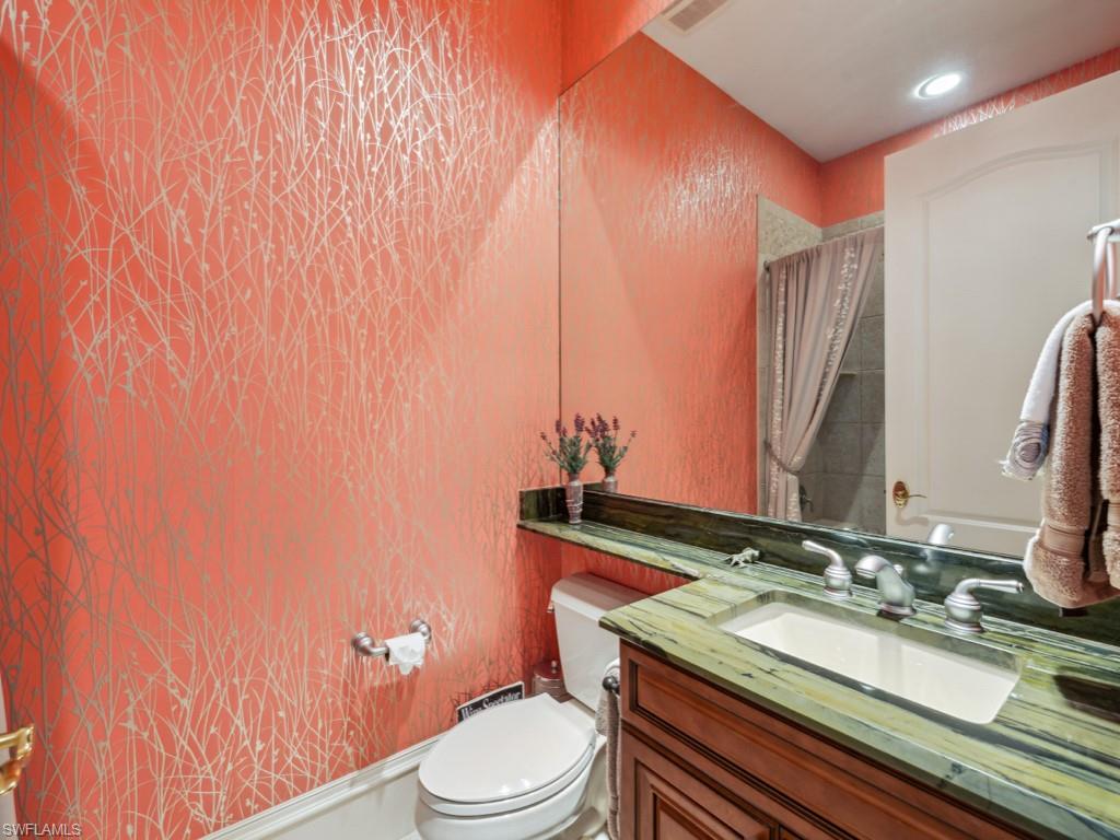 18112 Lagos Way Naples, FL 34110 - Photo 24 of 50 a bathroom with a granite countertop sink toilet and mirror