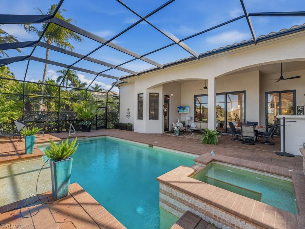 18112 Lagos Way Naples, FL 34110 - Photo 28 of 50 a swimming pool with outdoor seating