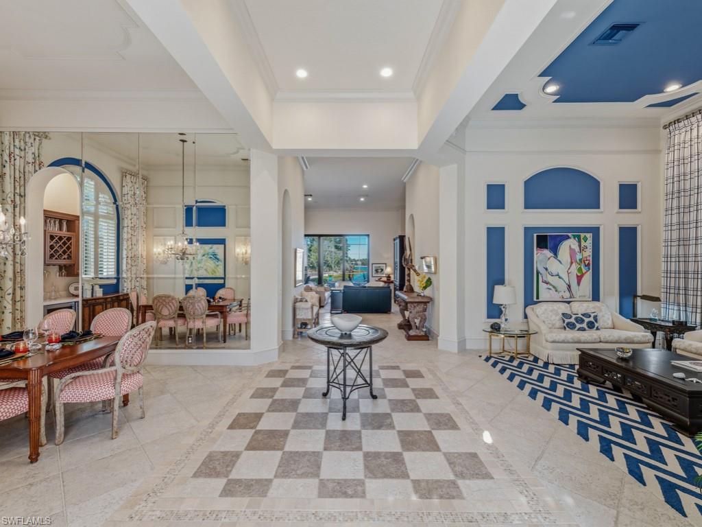 18112 Lagos Way Naples, FL 34110 - Photo 6 of 50 a living room with furniture a rug and white walls