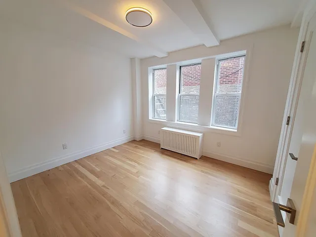a bedroom with bed and window