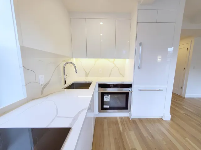 a view of kitchen with granite countertop cabinets and wooden floor