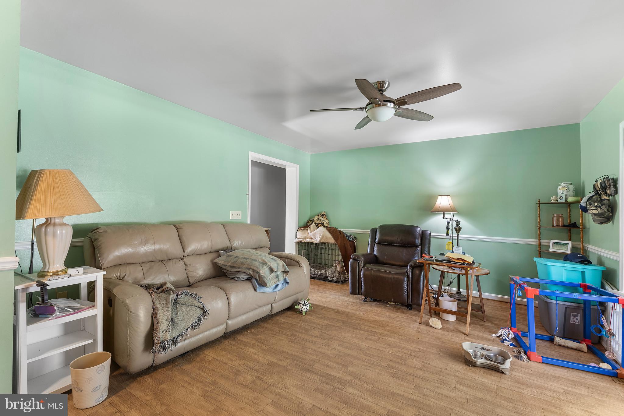 7112 East New Market Ellwood Road Hurlock, MD 21643 - Photo 19 of 41 a living room with furniture and a wooden floor