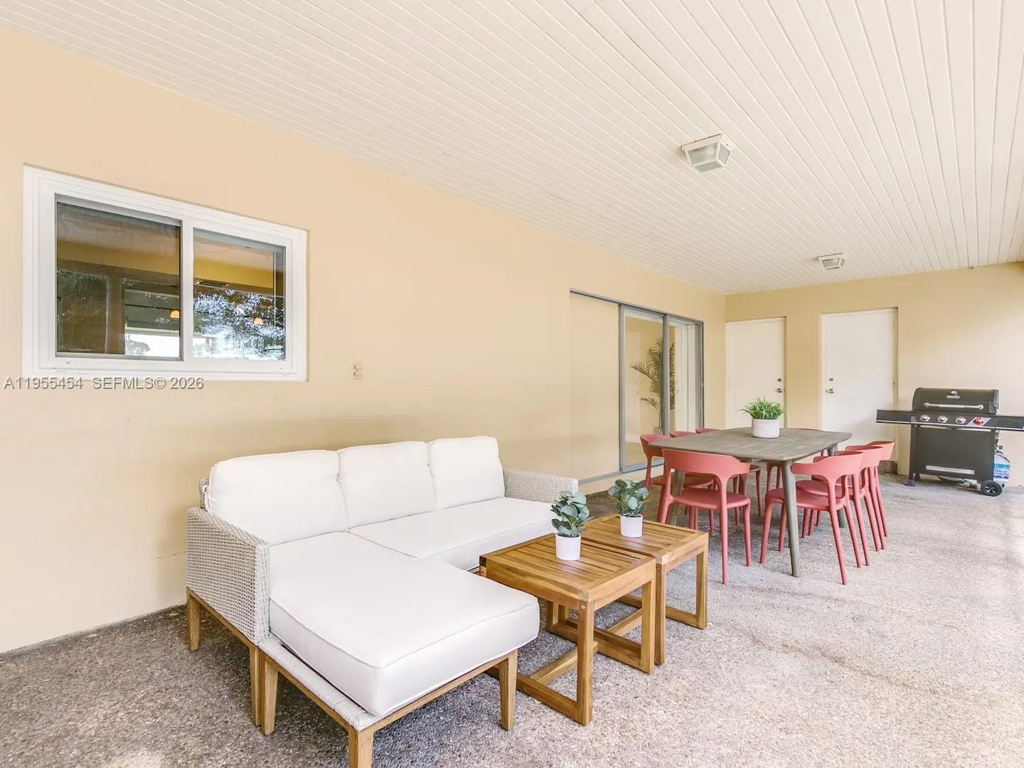 4800 Polk Street Hollywood, FL 33021 - Photo 13 of 26 a living room with furniture a table and a window