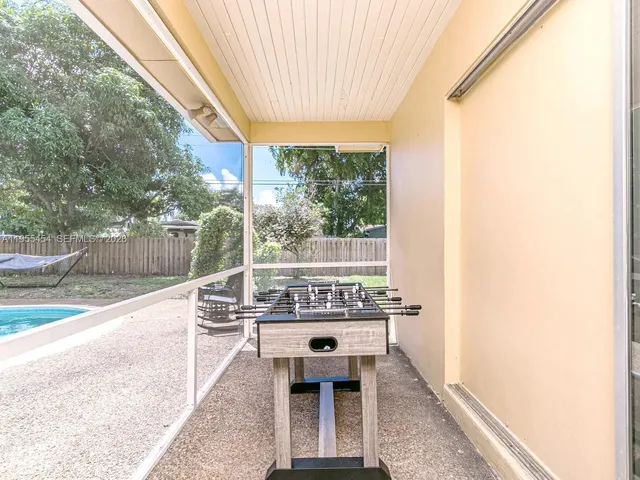 a white house with a large pool and yard