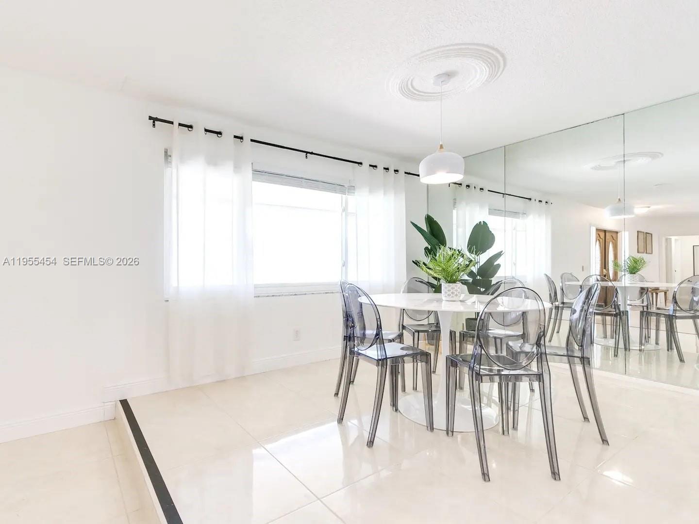 4800 Polk Street Hollywood, FL 33021 - Photo 17 of 26 a view of a dining room with furniture and a potted plant