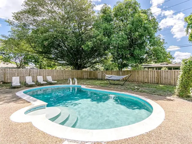 a bedroom with two beds and a chandelier