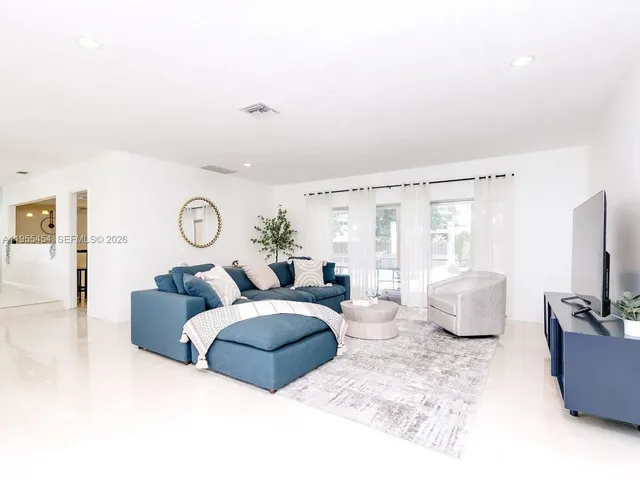 a living room with furniture and a large window