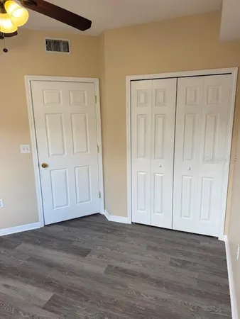 a view of a room with wooden floor