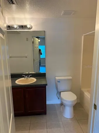 a bathroom with a shower a toilet and a sink