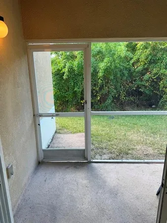 a view of a balcony with chair and floor to ceiling window