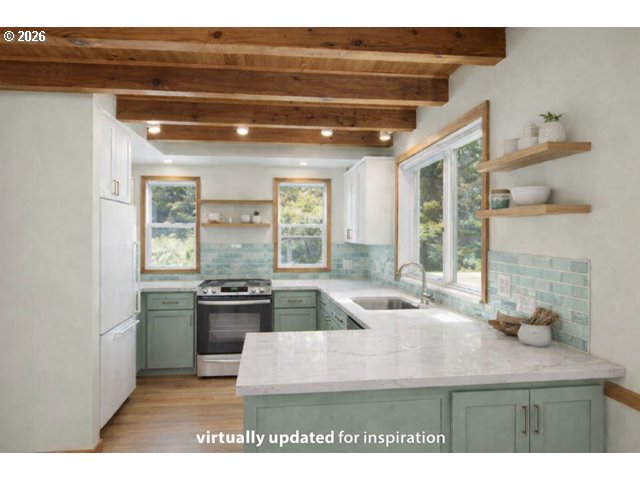 511 1st Street Manzanita, OR 97130 - Photo 27 of 28 a kitchen with stainless steel appliances granite countertop a sink stove and cabinets