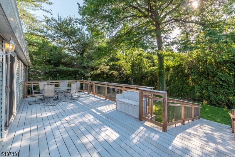 20 Wanaque Road West Milford, NJ 07421 - Photo 19 of 31 a view of house with deck outdoor seating and trees in the background