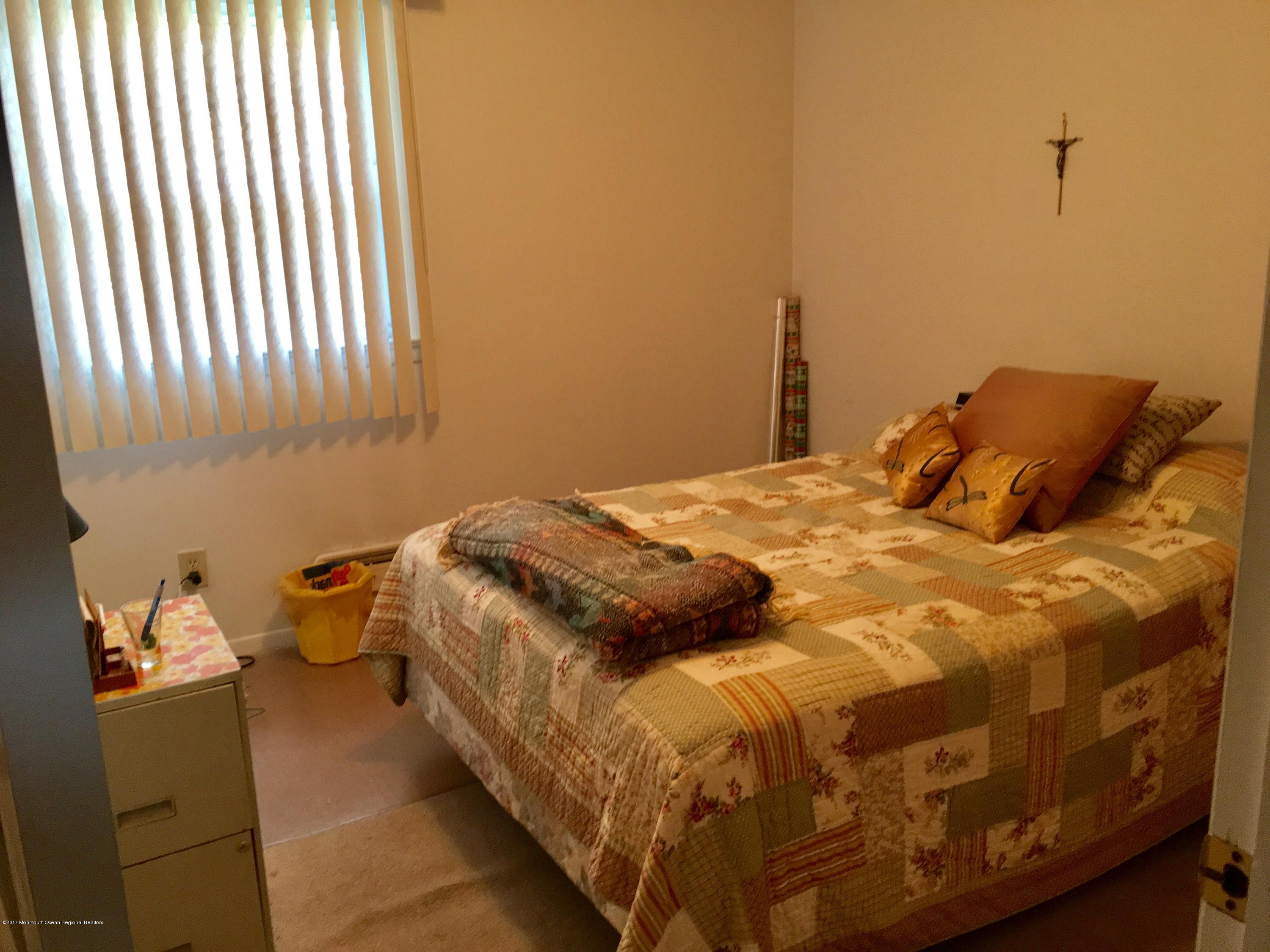 320 Eastham Road Point Pleasant, NJ 08742 - Photo 9 of 18 a bedroom with a bed and a window