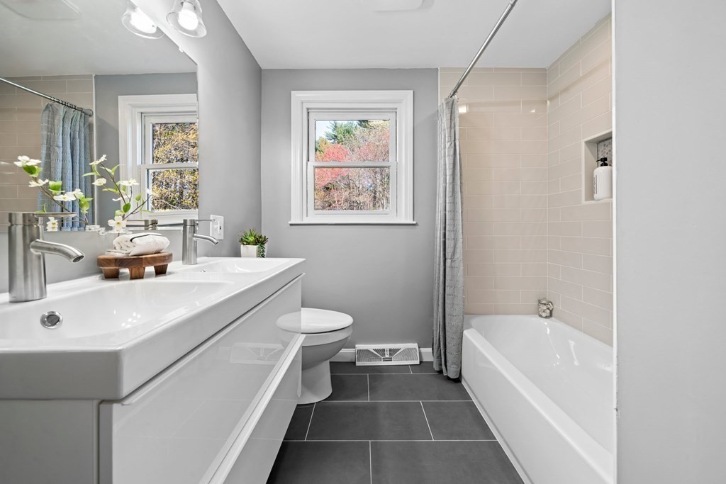 5 Shalloo Road Billerica, MA 01821 - Photo 19 of 42 a bathroom with a sink a toilet and a bathtub