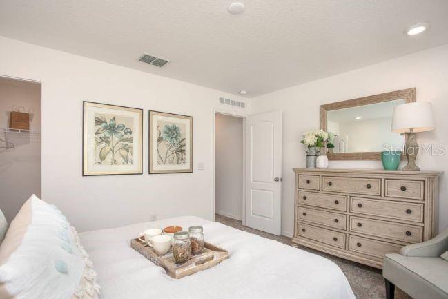 18 Hemlock Circle Pass Ocala, FL 34472 - Photo 12 of 29 a bedroom with a bed and a dresser