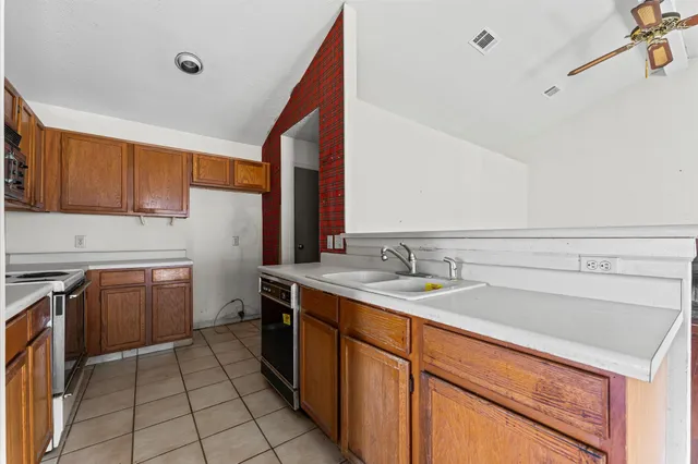 a kitchen with a sink cabinets and appliances