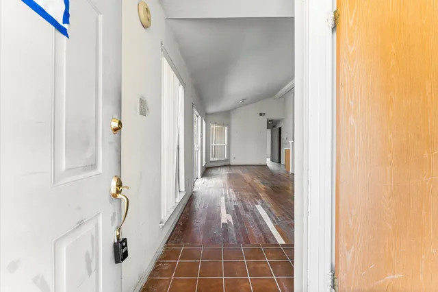 a view of hallway with wooden floor