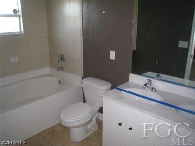 3714 13th Street Southwest Lehigh Acres, FL 33976 - Photo 5 of 5 a bathroom with a sink and a mirror