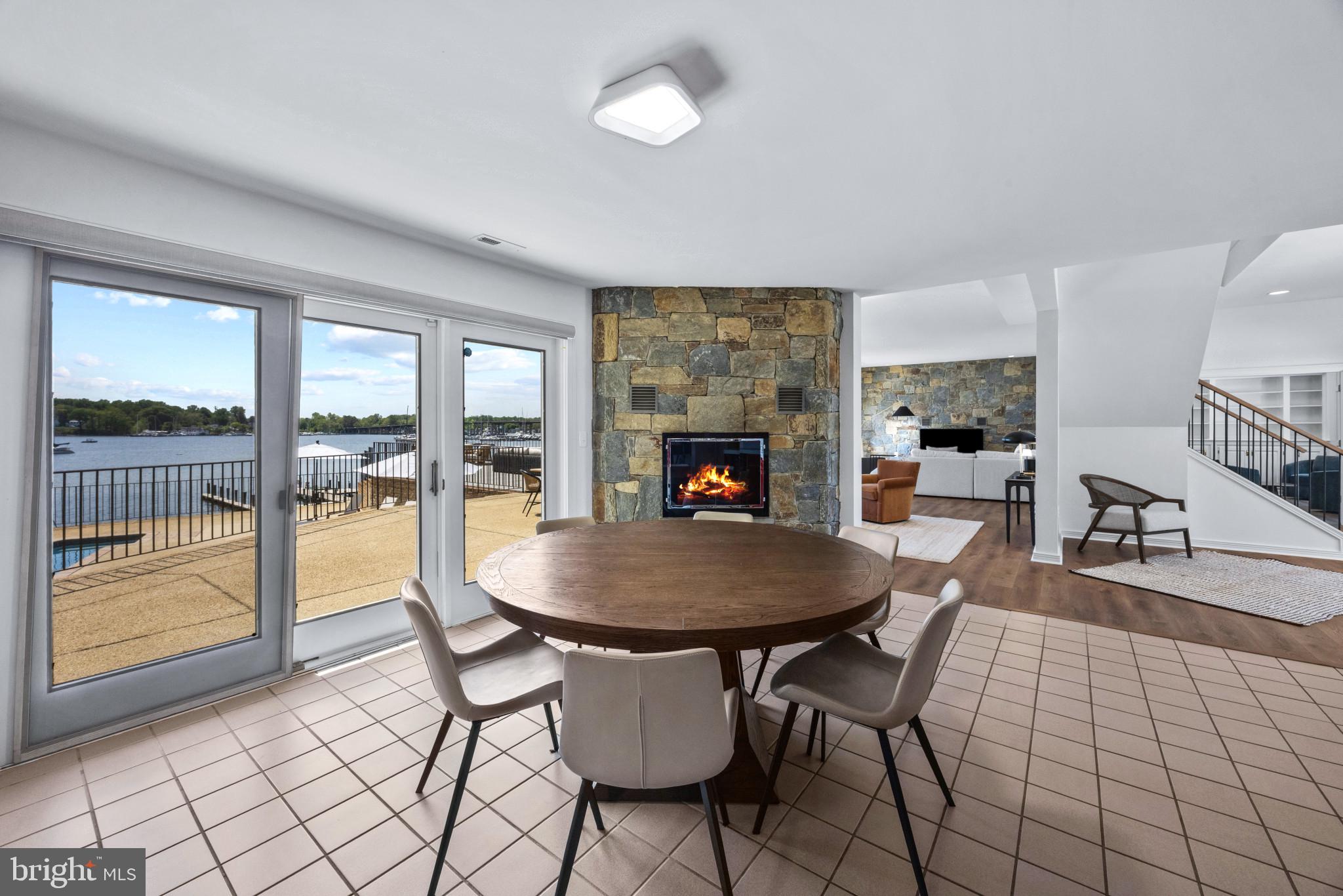 31 Shadow Point Court Edgewater, MD 21037 - Photo 13 of 44 Dining area with fireplace and access to rear deck