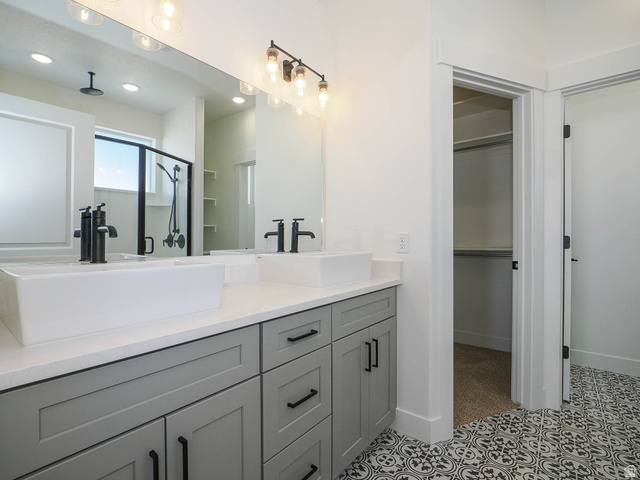 3938 North Wood Road Eagle Mountain, UT 84005 - Photo 20 of 55 Bathroom featuring double vanity, a stall shower, and a spacious closet