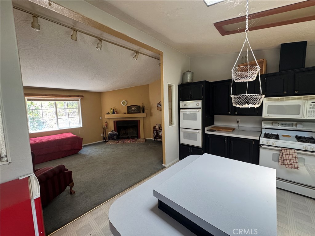 80 Rasmusen Lane Junction City, CA 96048 - Photo 11 of 67 a kitchen with kitchen island a stove and a wooden floors