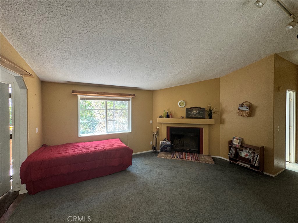 80 Rasmusen Lane Junction City, CA 96048 - Photo 12 of 67 a bedroom with a bed and a fireplace
