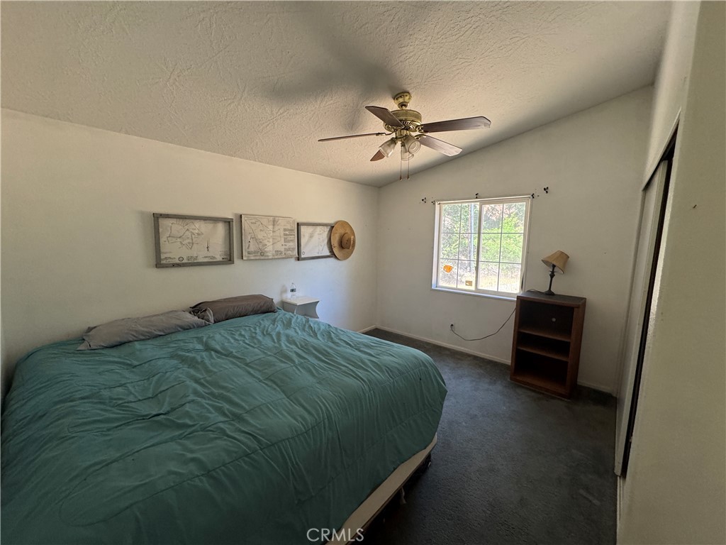 80 Rasmusen Lane Junction City, CA 96048 - Photo 18 of 67 a bed sitting in a bedroom next to a window