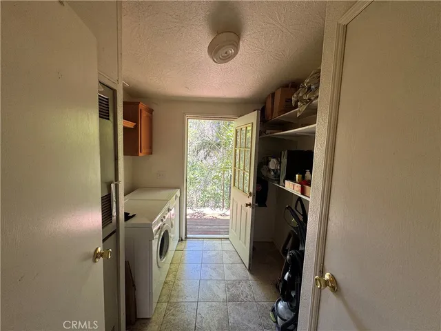 a living room with furniture a window and a flat screen tv