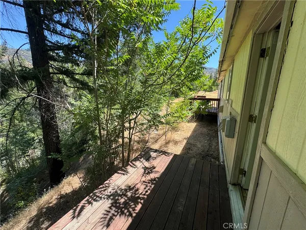 a view of balcony with wooden floor and outdoor seating