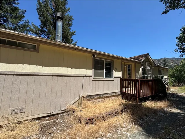 a wooden talbe and chairs sitting in the middle of a house
