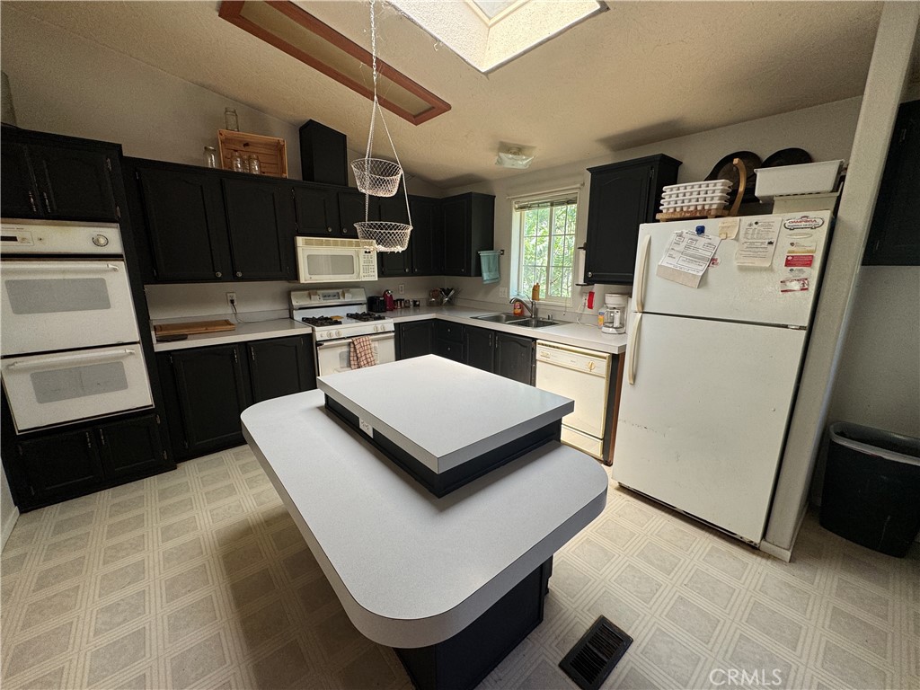 80 Rasmusen Lane Junction City, CA 96048 - Photo 10 of 67 a kitchen with a stove a refrigerator and a sink