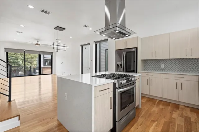 a kitchen with stainless steel appliances granite countertop a stove and a sink