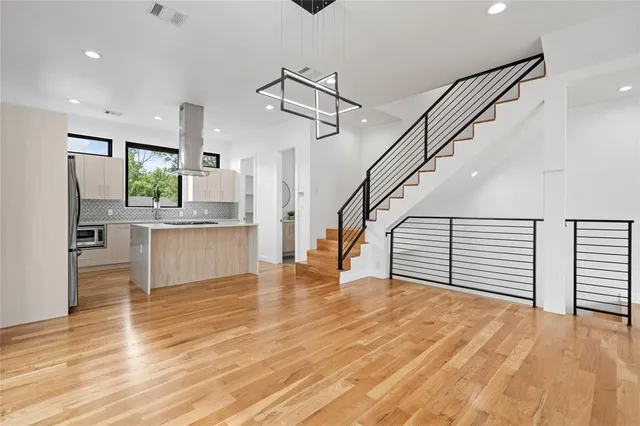 a view of a kitchen with wooden floor and electronic appliances