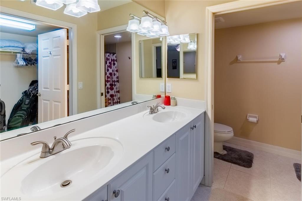 1100 Eastham Way, Unit A105 Naples, FL 34104 - Photo 15 of 27 a bathroom with a sink and a mirror