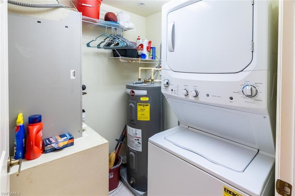 1100 Eastham Way, Unit A105 Naples, FL 34104 - Photo 17 of 27 a utility room with dryer and washer