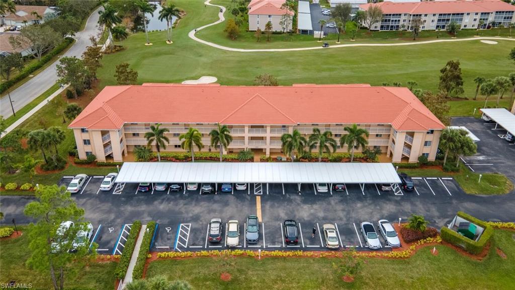 1100 Eastham Way, Unit A105 Naples, FL 34104 - Photo 19 of 27 a view of a lake with a house in the background
