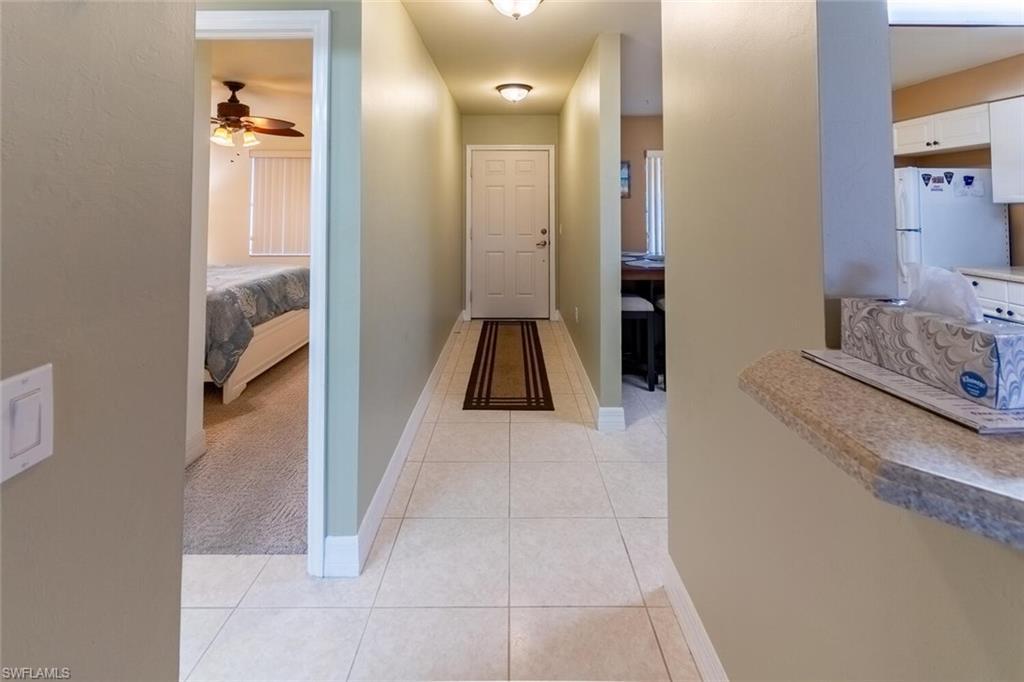 1100 Eastham Way, Unit A105 Naples, FL 34104 - Photo 2 of 27 a bathroom with a sink and a mirror